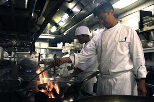 Thai Chef cooking with wok